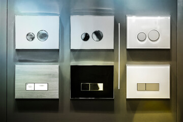 various types of buttons from plumbing installations at the stand, blurred image