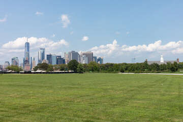 Lower Manhattan Skyline seen from a Green Grass Field on Governors Island in New York City during the Summer