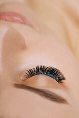 Eyelash Extension Procedure. Woman Eye with Long Eyelashes. Close up, selective focus. - 469376801