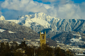 church tower against in the white Swiss mountains