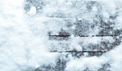 Winter background. Old boards covered with snow.