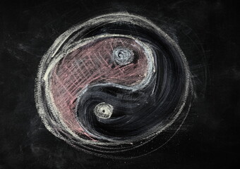 Hand drawn ying yang symbol on black chalkboard with colored chalk, blackboard texture and...