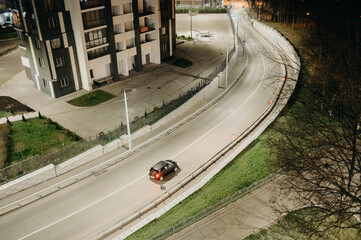 Long shutter photo of car in city track. Motion blur concept.