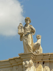Fototapeta na wymiar Statue of a woman holding a lantern, detail of the medieval city gate f Alba Iulia