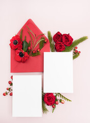Blank bridal wedding stationery invitation flat lay with fresh red anemone and rose flowers