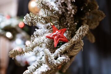 Different object toy gifts hanging on a decorated Christmas tree.