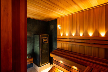 Interior of wooden finnish sauna with stove. The Finnish sauna is a substantial part of their...