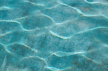 pool water surface with reflected sun glare for blue background