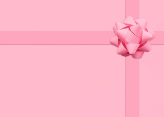 Gift. Template for posters and banners with copy space. Pink pastel lush bow on pink background. Minimal style
