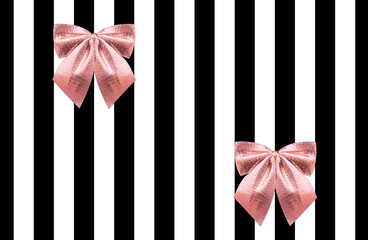 Naklejka premium Gift wrap design template in romantic style. Glowing rose gold bows on black-white striped backdrop