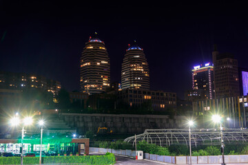 View of beautiful modern buildings, skyscrapers and towers of the night big city in Dnipro, Ukraine