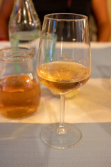 Summer on French Riviera Cote d'Azur, drinking cold rose from Cotes de Provence on outdoor terrase in old cafe, Var, France