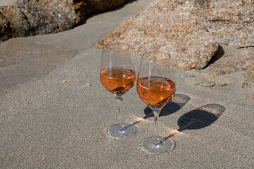 Summer time in Provence, two glasses of cold rose wine on sandy beach near Saint-Tropez, Var department, France