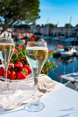 Summer party, pouring of French champagne sparkling wine in glasses in yacht harbour of Port Grimaud near Saint-Tropez, French Riviera vacation, France