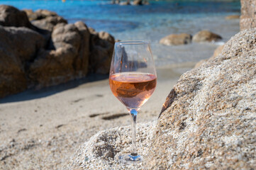 Summer time in Provence, glass of cold rose wine on sandy beach near Saint-Tropez, Var department, France