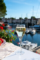 Summer party, pouring of French champagne sparkling wine in glasses in yacht harbour of Port Grimaud near Saint-Tropez, French Riviera vacation, France