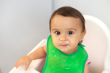 Funny face of an toddler after eating milk