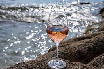 Summer time in Provence, glass of cold rose wine on sandy beach near Saint-Tropez, Var department, France