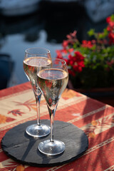 Romantic wedding party with two glasses of white cold champagne and view on yachts and houses of Port Grimaud, French riviera, France