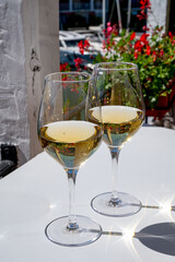Summer on French Riviera Cote d'Azur, drinking cold dry white wine from Cotes de Provence on outdoor terrase in Port Grimaud, Var, France