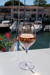 Summer on French Riviera Cote d'Azur, drinking cold rose wine from Cotes de Provence on outdoor terrase in Port Grimaud, Var, France