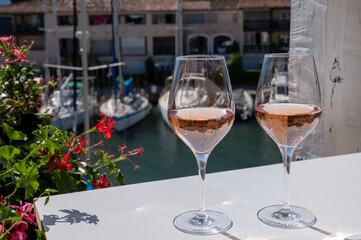 Summer on French Riviera Cote d'Azur, drinking cold rose wine from Cotes de Provence on outdoor terrase in Port Grimaud, Var, France