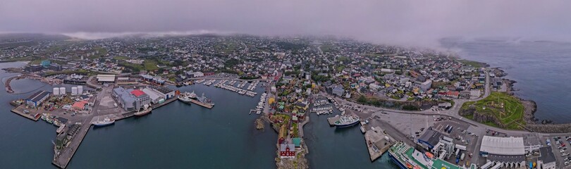 Beautiful aerial view of the City of Torshavn Capital of Faroe Islands- View of Cathedral, colorful buildings, marina, suburbs and Flag