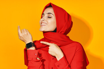 woman in red hijab with clock in hands technology emotions studio lifestyle