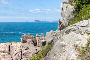 Rocks on cliffs and ocean in background