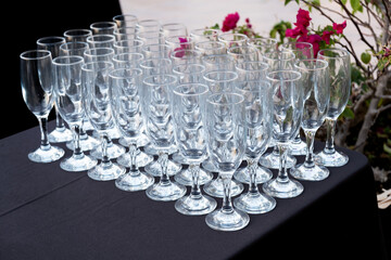 Many empty glasses for sparkling wine on the table. Selective focus. Preparation for buffet in the...