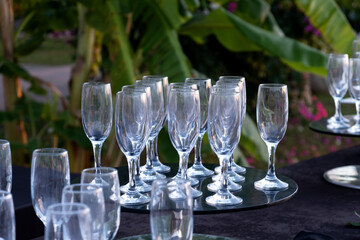 Empty glasses for sparkling wine on black table. Selective focus. Catering service. Holding events or celebrations in the open air