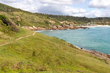 Fototapeta na wymiar Trail to the beach with rocks and and vegetation