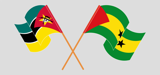 Crossed and waving flags of Mozambique and Sao Tome and Principe