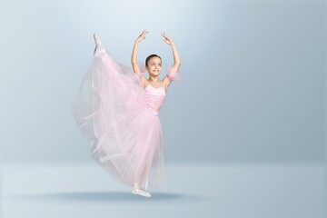 Tips on toes. Young graceful ballerina dancing alone on background.