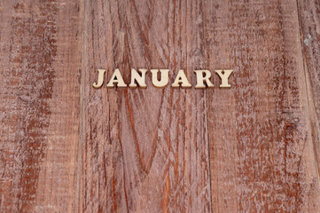 January month. The name of the months on a wooden background. Template for a calendar.