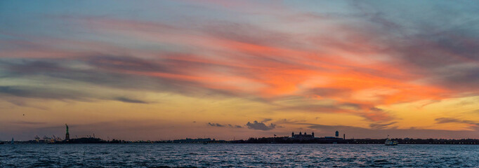 Sunset over the hudson river, Ellies Island and Statue of Liberty in the background