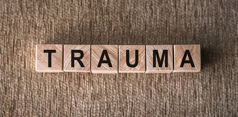 the word trauma written on wooden cubes