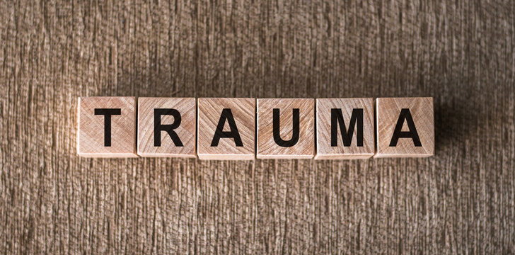 the word trauma written on wooden cubes