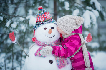 Cute girl is making a snowman.