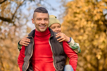 Dad and daughter playing in the park and looking happy