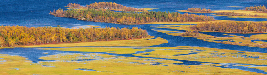 Panoramic view of the estuary of River Ivalojoki in Lapland, Finland. Landscape in autumn colors.