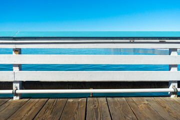 Pier railing with ocean and sky in San Clemente, California