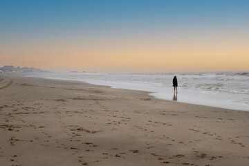 lonely woman walks by the seashore