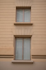 Windows of an old building with orange walls and lines