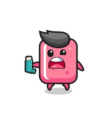 Fototapeta premium bubble gum mascot having asthma while holding the inhaler