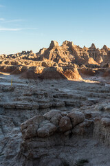 Jagged sandstone mountains illuminated from the sun in Badlands National Park