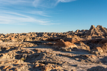 Jagged sandstone mountains illuminated from the sun in Badlands National Park