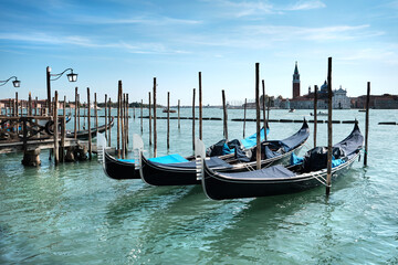 Fototapeta na wymiar Venice gondolas. Gondolas moored by Saint Mark square with San Giorgio di Maggiore church in the background. Venice, Venezia, Italy, Europe.