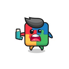 Fototapeta premium puzzle mascot having asthma while holding the inhaler
