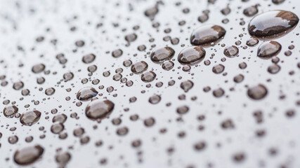 Pattern of water drops in a shining metallic surface with sky reflections,Water droplet on the car hood. Realistic pure water droplet water drops for creative banner design